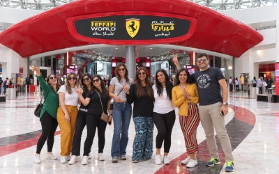 Travelers taking a photo with the famous Ferrari world Them Park entrance