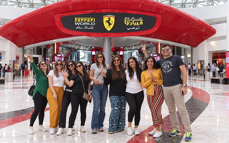 Travelers taking a photo with the famous Ferrari world Them Park entrance