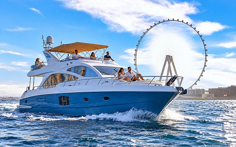 Guests enjoying a shared yacht tour in Dubai Marina with views of the Ain Dubai